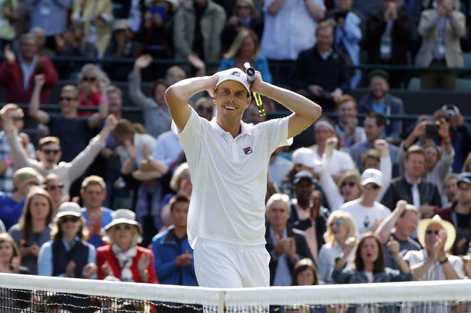 Sam Querrey of the U.S celebrates after beating Novak Djokovic of Serbia in their men's singles match on day six of the Wimbledon Tennis Championships in London, Saturday, July 2, 2016. (AP Photo/Alastair Grant)