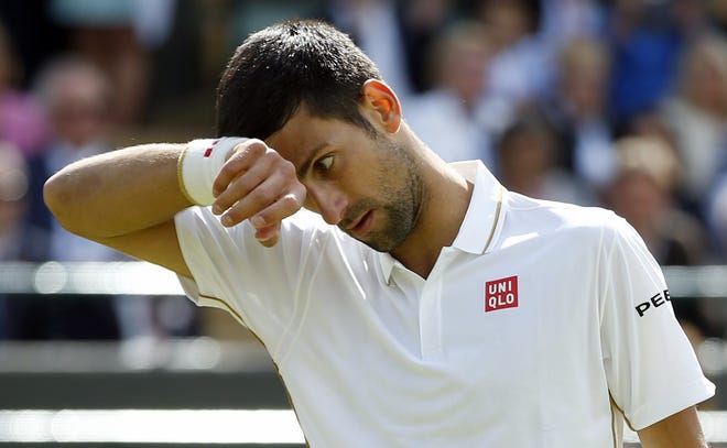 Novak Djokovic wipes his face during his men's singles loss to Sam Querrey. Djokovic had won the last four Grand Slams — Wimbledon, U.S. Open, Australian Open and French Open — and 30 consecutive Grand Slam matches. The Associated Press