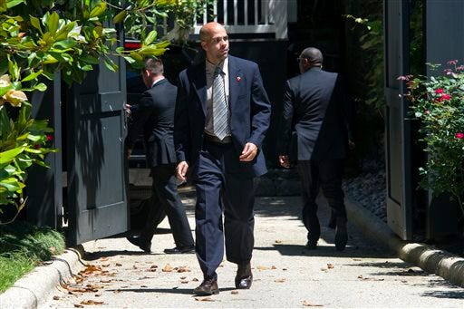 A Secret Service agent stands guard while two other agents close a gate after a Secret Service vehicle arrived at the home of Democratic presidential candidate Hillary Clinton in Washington, Saturday, July 2, 2016. The Clinton campaign says the FBI interviewed Clinton on Saturday morning in Washington, about her emails while she was secretary of state. (AP Photo/Cliff Owen)
