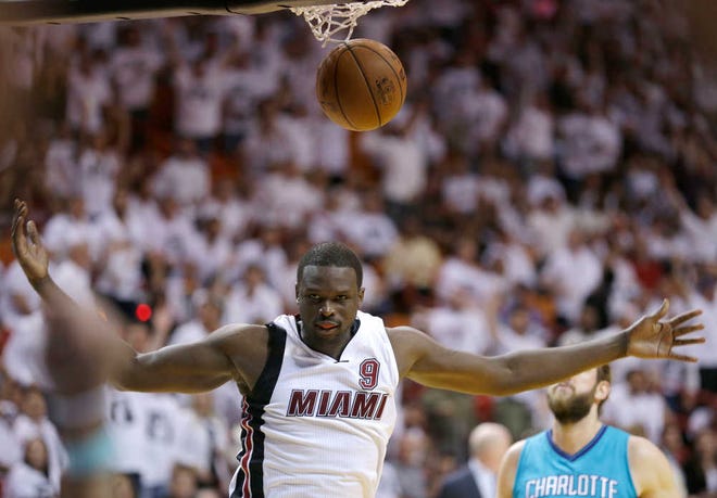FILE - In this April 20, 2016 file photo, Miami Heat forward Luol Deng scores against the Charlotte Hornets during the second half of Game 2 of a first-round NBA basketball playoff series in Miami.  A person with knowledge of the situation tells The Associated Press that the Los Angeles Lakers have agreed to terms with Deng on a four-year contract worth $72 million. The two sides came to agreement early Saturday, July 2. The person spoke on condition of anonymity because the deal cannot be signed until July 7. (AP Photo/Alan Diaz, file)
