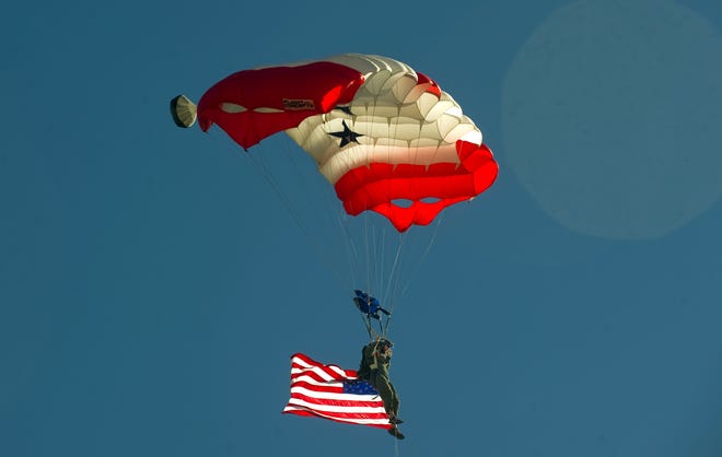 Skydiver Brian Folmer soars over the Freedom Fest celebration at the Home Church, which has been putting on Freedom Fest every Sunday before Independence Day for more than a decade. CLIFFORD OTO/THE RECORD
