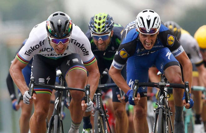Peter Sagan, of Slovakia, left, crosses the finish line ahead of France's Julian Alaphilippe, right, and Spain's Alejandro Valverde to win the second stage of the Tour de France on Sunday. (AP Photo/Christophe Ena)