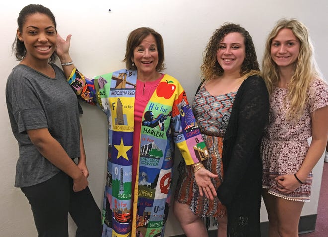 Teacher of the Year Dana McDonough, second from left, said she is thrilled with a paneled robe made for her by some of NFA's fashion students. The panels represent different regions of the state. McDonough teaches in the Newburgh district. She is pictured with seniors, from left, Kim Rapisarda, Kiara Rivera and Valerie Ernest. PAULINE LIU/TIMES HERALD-RECORD