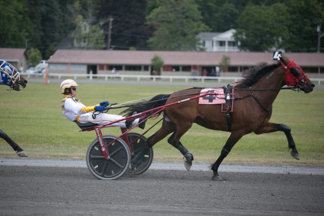 Permanent Joy, driven by Wally Hennessey, a 2006 Harness Racing Hall of Fame inductee, finishes sixth in the Hall of Fame Trot at Goshen Historic Track on Sunday. Allyse Pulliam for the Times Herald-Record