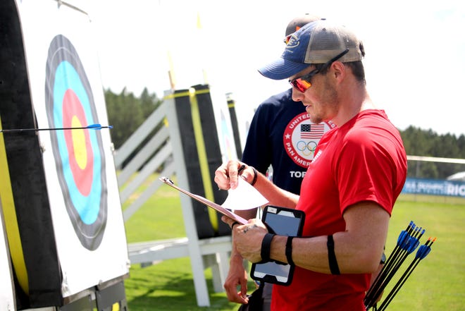 Jake Kaminski checks his notes while competing for a spot on the U.S. Olympic archery team during trials at the Newberry Sports Complex. Kaminski, a 2012 Olympic silver medalist, made the team. Deshlee Ford/Gatehouse Media Services