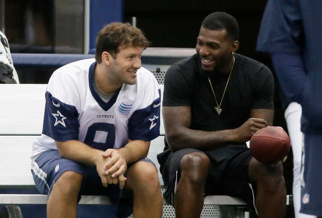FILE - In this June 18, 2015, file photo, Dallas Cowboys wide receiver Dez Bryant, right, sits on the bench with quarterback Tony Romo (9) during NFL football minicamp at the team's stadium in Arlington, Texas. Both are anxious to get on the field together after injuries kept them apart most of last season, when Dallas slid from first to worst in the NFC East. (AP Photo/LM Otero, File)