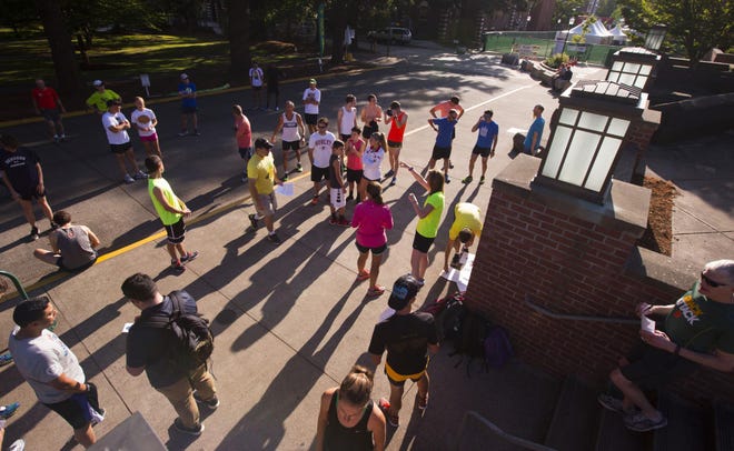 Dozens of participants gather in front of the The University of Oregon Recreation Center near the entrance to Hayward Field on campus before the run. (Chris Pietsch/The Register-Guard)