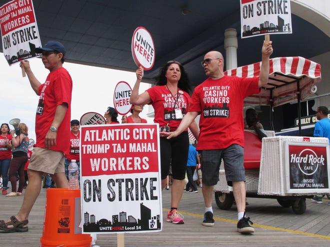 Striking union members picket outside the Trump Taj Mahal casino in Atlantic City, N.J., Sunday. The strike by Local 54 of the Unite-HERE union was in its third day with no new talks scheduled.