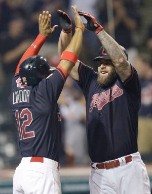Cleveland Indians' Mike Napoli, right, is congratulated by Francisco Lindor after Napoli hit a two-run home run off Detroit Tigers' Bruce Rondon in the seventh inning of a baseball game, Tuesday, July 5, in Cleveland. Lindor scored on the play. (AP Photo/Tony Dejak)