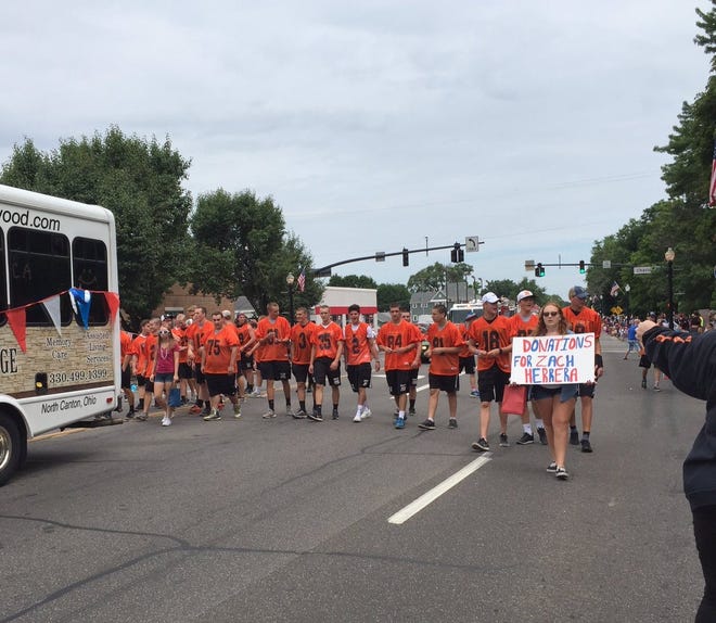 Members of the Hoover High football team march in support of Zach Herrera during Fourth of July parade in North Canton on July 4, 2016.