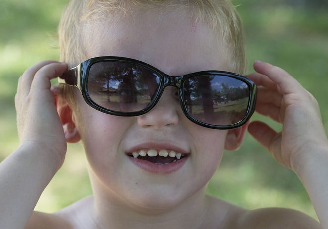 Shane Devlin, 4, of Bristol Township, puts on mom Christine's sunglasses while cooling off in the shade at Falls Township Community Park on Wednesday, July 6, 2016, when temperatures were in the low 90s. On Thursday, the temperature is expected to reach into the mid 90s.