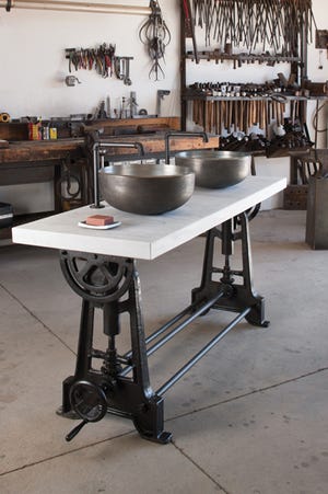 The Industrial Console is reminiscent of a 1920s cast-iron pattern-making table with a marble top. Here, it is paired with two vessel sinks. Ferguson Plumbing, $9,700 (console only).