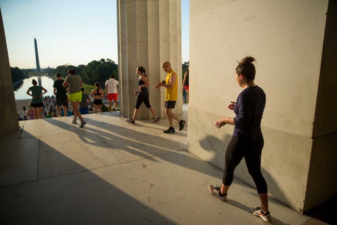 Members of the running group "November Project" run up and down the stairs of the Lincoln Memorial in Washington.