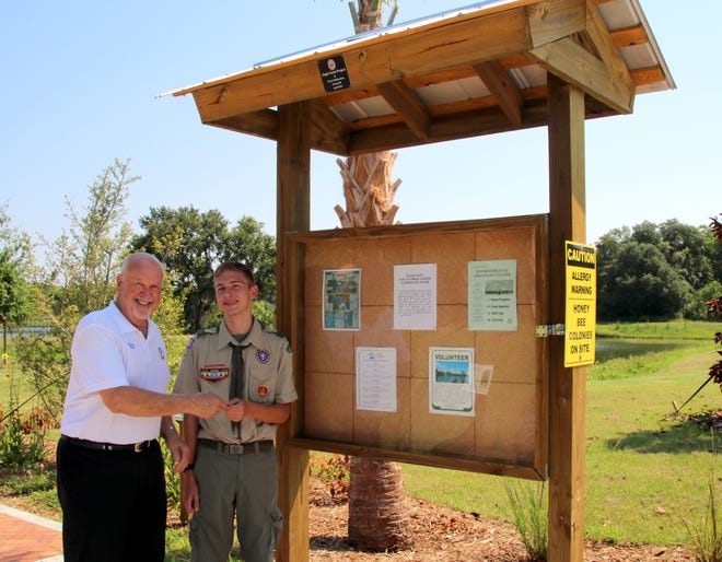 Ormond Beach Mayor Ed Kelley, left, presents Trevor Richardson with a token of the city's appreciation after Richardson completed his Eagle Scout project.