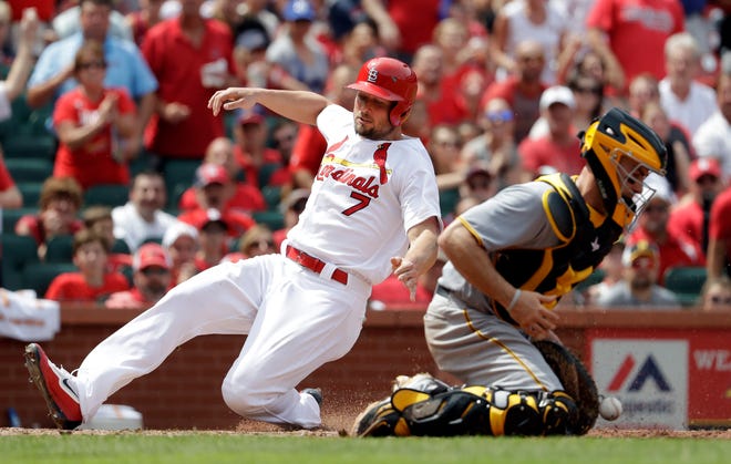 St. Louis Cardinals' Matt Holliday, left, scores past Pittsburgh Pirates catcher Eric Fryer during the sixth inning of a baseball game Thursday, July 7, 2016, in St. Louis. The play was first ruled a double by Cardinals' Stephen Piscotty, but was changed to a three-run home run after review. (AP Photo/Jeff Roberson)