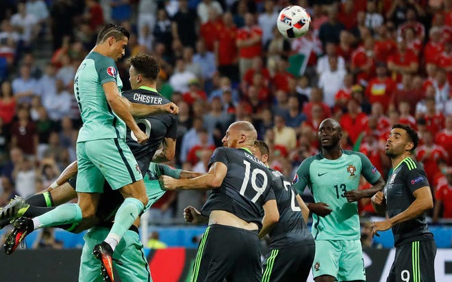 Portugal's Cristiano Ronaldo scores on a header during the Euro 2016 semifinal soccer match between Portugal and Wales, at the Grand Stade in Decines-Charpieu, near Lyon, France, Wednesday, July 6, 2016. (AP Photo/Frank Augstein)