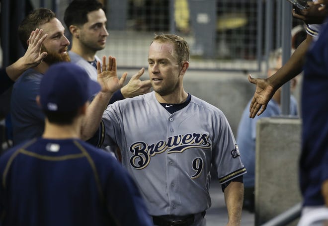 Aaron Hill (center) is greeted by Brewers teammates during a recent game. The 34-year-old infielder was dealt to the Red Sox on Thursday.
