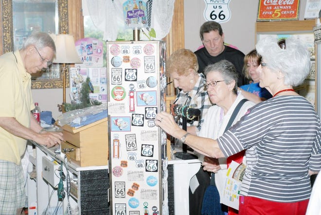 Trips Unlimited Group Tour, a tourist group from New Orleans, La., keeps Bob Harbin, left, busy at the gift shop in the Route 66 Association of Illinois Hall of Fame and Museum.