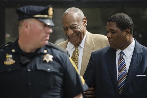 Bill Cosby, center, leaves a pretrial hearing in his criminal sex-assault case at Montgomery County Courthouse in Norristown, Pa., Thursday, July 7, 2016. A Pennsylvania judge denied Cosby's effort to compel the accuser in his case to testify before trial. (AP Photo/Matt Rourke)
