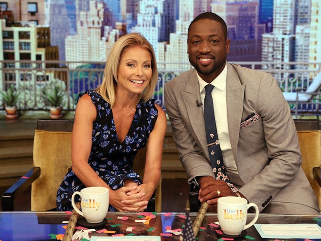 In this image provided by ABC Home Entertainment and TV Distribution, TV host Kelly Ripa and NBA basketball player Dwyane Wade pose during the production of "Live Kelly" in New York, Thursday, July 7, 2016. Wade decided Wednesday night, July 6, 2016, that he will leave the Miami Heat after 13 seasons, agreeing to terms on a two-year-$47 million contract with the Chicago Bulls.