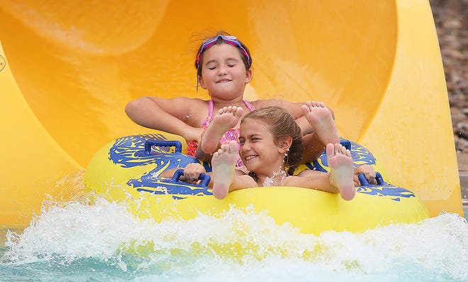 TIMES-REPORTER/JIM CUMMINGS

Kinsey Quillin, 7, (back) and Addie Worst, 9, (front), both of New Philadelphia, ride the double tube at the Uhrichsville Water Park this week.