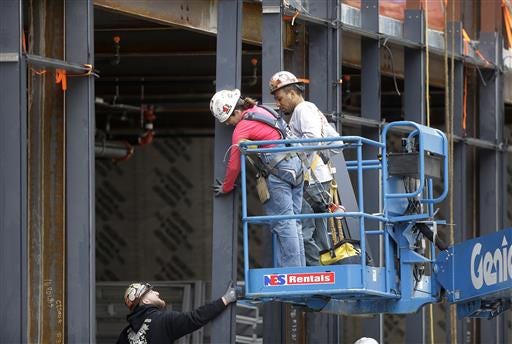In this Thursday, May 19, 2016, photo, workers construct a building in Boston. On Friday, July 8, the U.S. government issues the June jobs report. (AP Photo/Steven Senne)