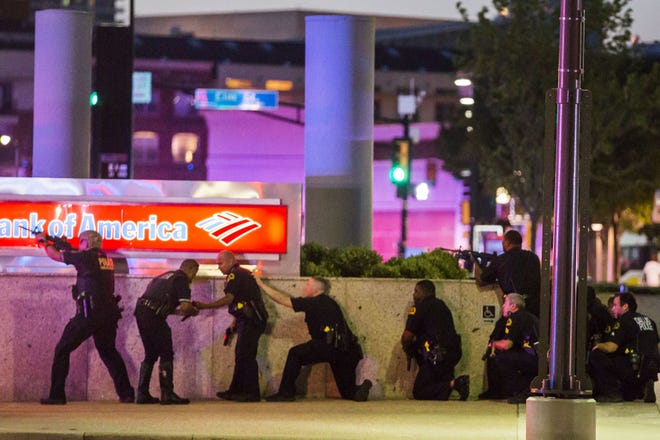 Police respond Thursday after shots were fired during a Black Lives Matter rally in downtown Dallas. Five officers were killed and seven wounded when an unknown number of gunmen fired on officers during the rally.