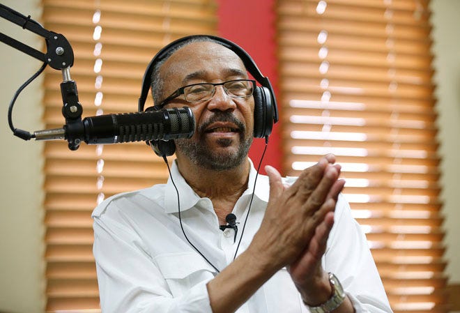 The Rev. Michael Reeves talks to a guest during his radio show on WVKO-AM 1580 "The Praise" on Friday.