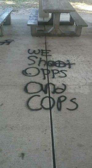 The words "We Shoot Opps and Cops" were spray-painted at Pettis Park in New Smyrna Beach, and found by a woman who took her grandchildren to the park Saturday morning, according to a community group's Facebook post. "OPPS" is slang for the "opposition," said people commenting on the post. Photo provided