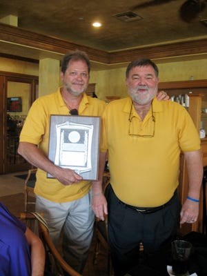 Lions President Ted Evens, right, presents Kevin Hannah with the Lion of the Year Award.