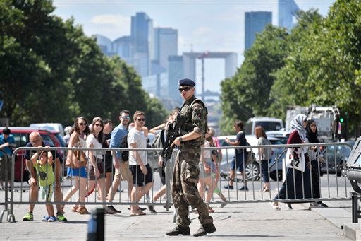 A French soldier patrols in the streets of Paris Saturday July 9, 2016. French police and troops are gearing up for their biggest security challenge since the deadly Nov. 13 attacks across Paris last year, as hundreds of thousands of fans mass in the French capital for Sunday's Euro 2016 European Soccer Championship final. (AP Photo/Martin Meissner)