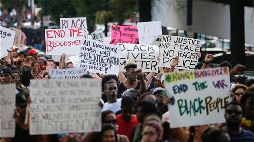 Demonstrators march through downtown Atlanta to protest the shootings of two black men by police officers, Friday, July 8, 2016. Thousands of people marched along the streets of downtown to protest the recent police shootings of African-Americans. Atlanta Police Chief George Turner and Atlanta Mayor Kasim Reed said earlier in the day that people have the right to protest this weekend but urged them to cooperate with law enforcement. (AP Photo/John Bazemore)