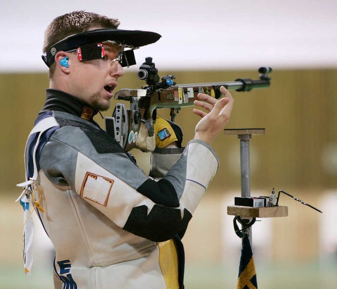 During the 2004 Olympics in Athens, Matthew Emmons signals to officials that he fired his gun during the final round of the men's 50m rifle 3 position finals. Instead of aiming at his target, he fired at another competitor's target. The error sent the marksman from first place and a gold medal to last.