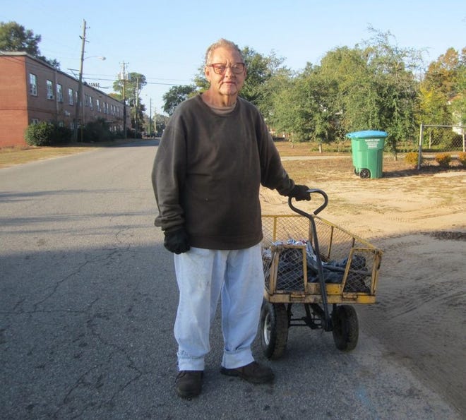During his daily quest for aluminum cans to recycle, Crestview's “can man,” Elvit Enlow, pauses down the street from the Crestview Manor, where he lives.