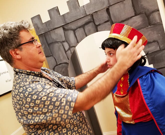 Director Matthew Bruffee of Middleboro works on a costume with Zackery Lowell of Middleboro, a member of the cast for Burt WoodþÄôs presentation of þÄúShrek The Musical.þÄù The show opens July 14. Submitted