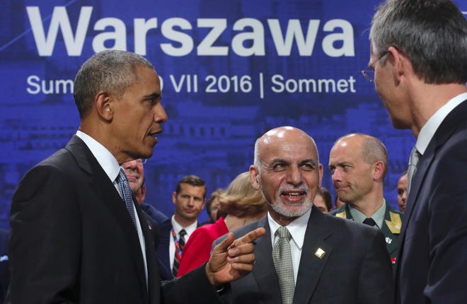 US President Barack Obama gestures next to Afghan President Ashraf Ghani and NATO Secretary General Jens Stoltenberg, right, at the NATO summit in Warsaw, Poland, Saturday, July 9, 2016. U.S. President Barack Obama and other NATO leaders have begun the second day of a summit meeting in Warsaw that's expected to lead to decisions about Afghanistan, the central Mediterranean and Iraq. (AP Photo/Markus Schreiber)
