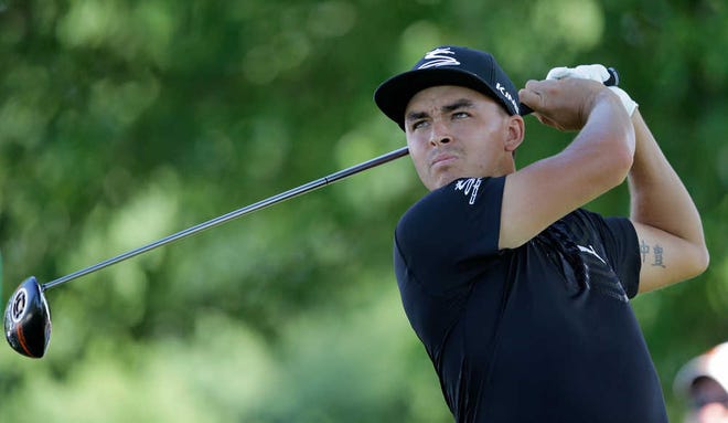 FILE - In a June 30, 2016 file photo, Rickie Fowler tees off on the 18th hole during the first round of the Bridgestone Invitational golf tournament at Firestone Country Club, in Akron, Ohio. Fowler says on Twitter on Sunday, July 10, 2016, that he's going to the Olympics, and Patrick Reed said he would be joining him in Rio. (AP Photo/Tony Dejak, File)