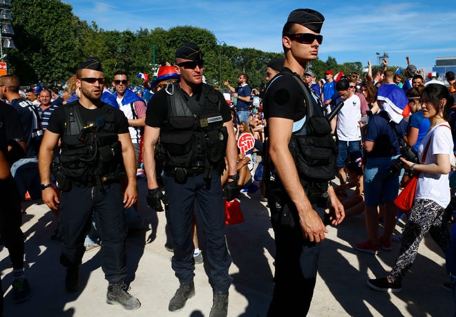 French police officers patrol in the Paris fan zone before the Euro 2016 final soccer match between Portugal and France, Sunday, July 10, 2016 in Paris.