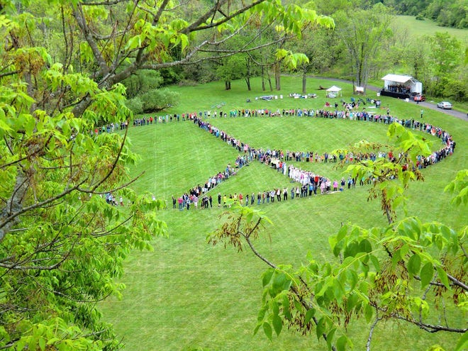 Hundreds of people joined to create a giant human peace sign May 22, 2016, at Bucks County Community College in Newtown Township. The event was sponsored by the Peace Center in Langhorne.