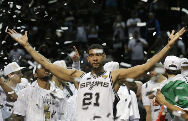 Spurs forward Tim Duncan (21) celebrates in June 2014 after the Spurs won their fifth NBA title during his 19-year career.  Duncan announced his retirement on Monday, July 11, 2016, after earning two MVP awards and making 15 All-Star appearances.