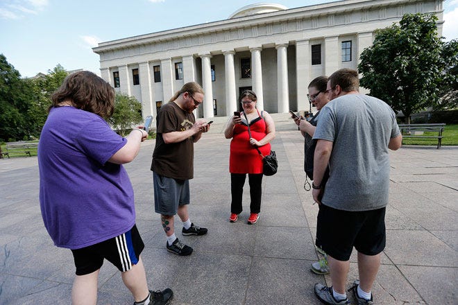 Josh Murphy, 24, of Grove City, Trevor Surratt, 28, of the East Side, his wife Debbie Surratt, 26, Millie Blake, 27, of North Linden and her husband Michael Blake, 27, play Pokémon GO on their cell phones outside the Ohio Statehouse.