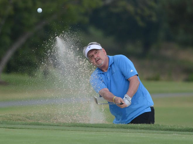 David Rubel hits a shot out of the bunker on the ninth hole during Monday's first round of the County Senior Amateur at the Country Club of Spartanburg.