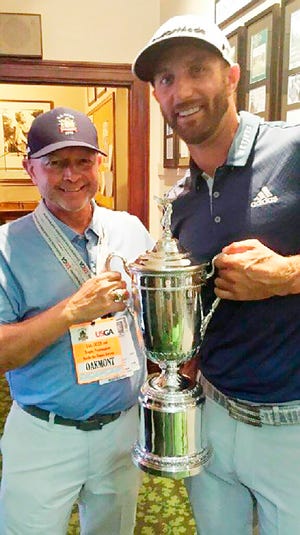 Oklahoma native and Putnam City High alum David Winkle (left) holds the U.S. Open Championship Trophy with Dustin Johnson after his longtime client won the major tournament earlier this summer.