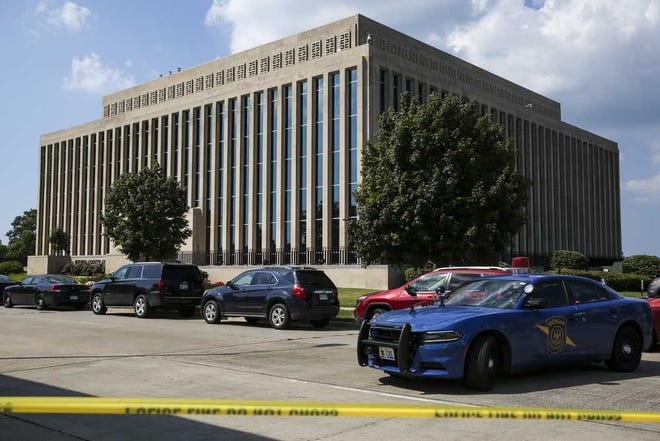 Police tape surrounds the Berrien County Courthouse on Monday, July 11, 2016 in St. Joseph, Mich. Two bailiffs were fatally shot Monday inside the courthouse before officers killed the gunman, a sheriff said. (Chelsea Purgahn/Kalamazoo Gazette via AP)