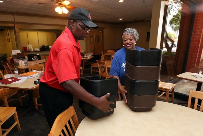 Jackie Wilson, head line server and employee of Piccadilly Cafeteria for 46 years, and Brenda Mason, cashier and line server and employee for 37 years, move supplies in the former Piccadilly Cafeteria location inside University Mall on Monday.