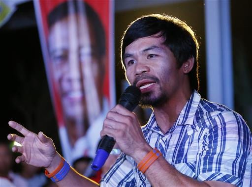 FILE- In this April 28, 2016, file photo, boxing star Manny Pacquiao addresses supporters as he campaigns for a seat in the Philippine Senate at San Pablo city, Laguna province south of Manila, Philippines. Pacquiao, who said before his last fight in April that he would retire, now plans to return to the ring in November against an opponent who has yet to be selected. Promoter Bob Arum said Tuesday, July 12, that Pacquiao got permission to take a break from his new duties as a senator in the Philippines to take another fight. (AP Photo/Bullit Marquez, File)