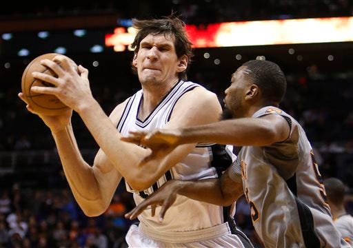 FILE - In this Jan. 21, 2016, file photo, San Antonio Spurs center Boban Marjanovic, left, works the ball inside during the third quarter of an NBA basketball game against the Phoenix Suns in Phoenix. The Detroit Pistons have signed Marjanovic to a $21 million, three-year contract, the team announced Tuesday, July 2, 2016. (AP Photo/Rick Scuteri, File)