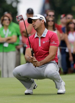 Jason Day, from Australia, reacts after missing a birdie putt on the 11th hole during the final round of the Bridgestone Invitational golf tournament at Firestone Country Club, Sunday, July 3, 2016, in Akron, Ohio. Dustin Johnson won the tournament. (AP Photo/Tony Dejak)