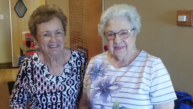 Janet Hickey, left, formerly of Elkhart now living in Sherman and Doris Langengahan, of Lincoln, were winners at the Oasis July birthday celebration. They had the most correct answered to clues that ended with the letters "ice". They won a gift bag from CastleManor that included a bike clock, oven mitts and a fancy cup with a straw. Photo by Jean Ann Miller/The Courier