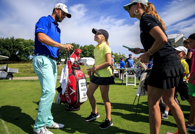 Aislyn Grant, 10, gets the autograph of Wesley Bryan, left, who is leading the Web.com Tour regular season money list, after a junior golf clinic for the Web.com Tour at Lincoln Land Charity Championship at Panther Creek Country Club, Tuesday, July 12, 2016, in Springfield, Ill. Justin L. Fowler/The State Journal-Register